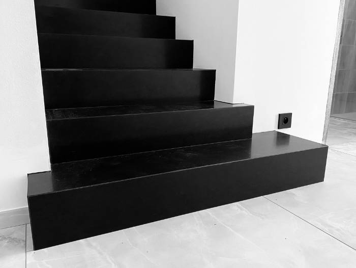 Escalier en marbre noir du Zimbabwe rénové par l'architecte d'intérieur Sophie Jacquemin Interior Design basée à Genève